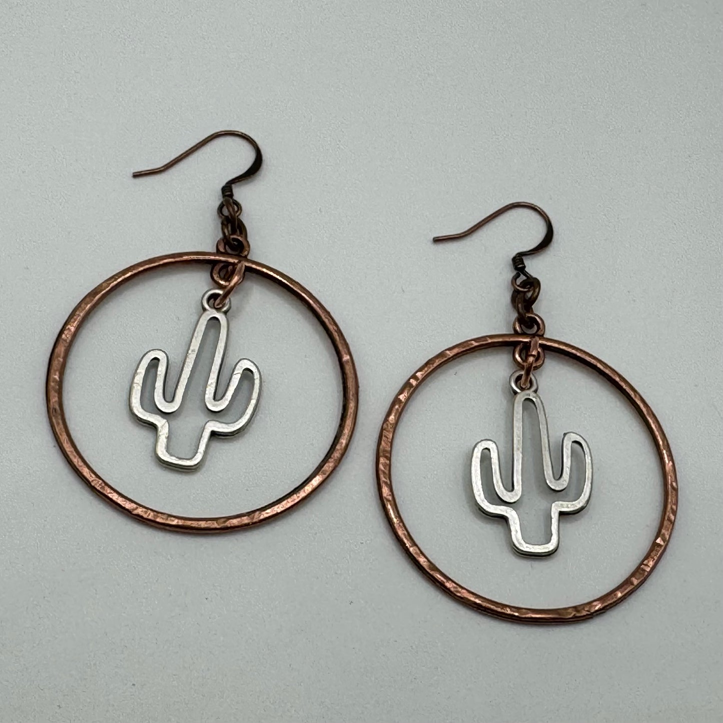 Chunky silver saguaros in copper rings