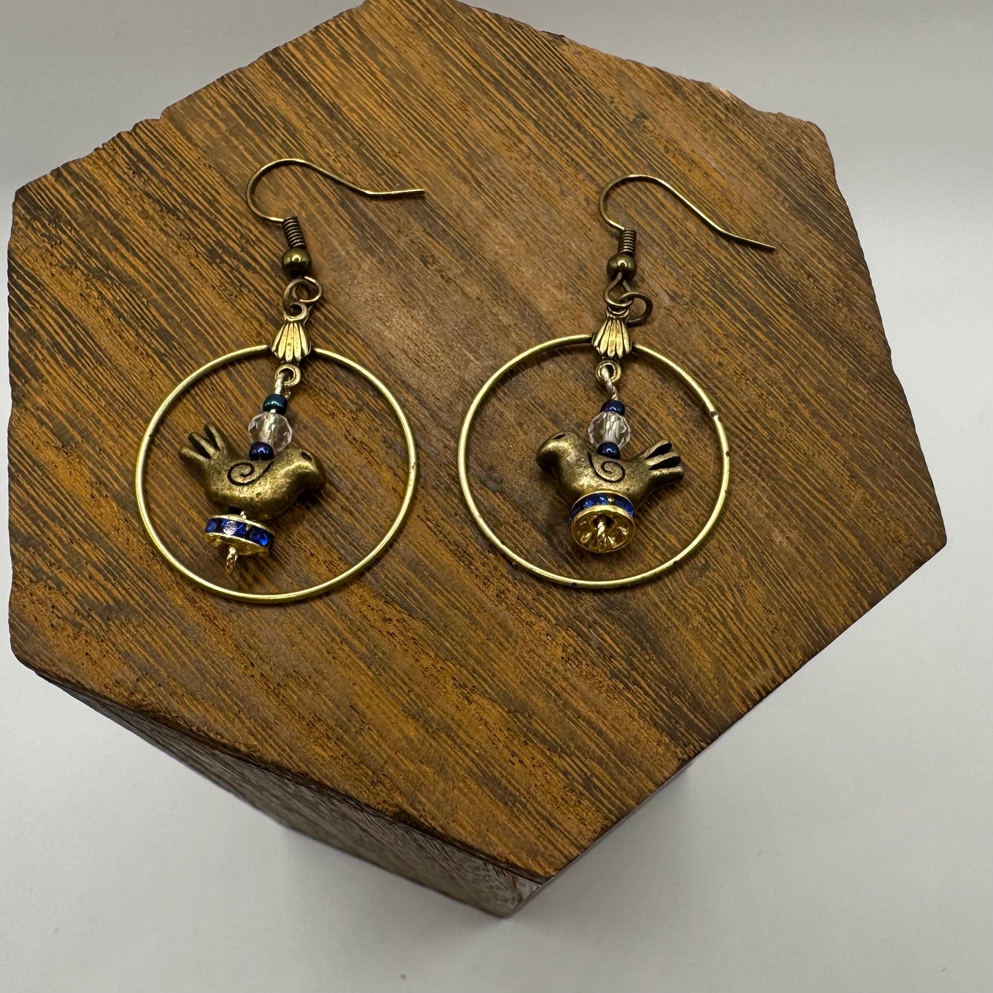 Bronze hoop earrings with birds and blue crystals