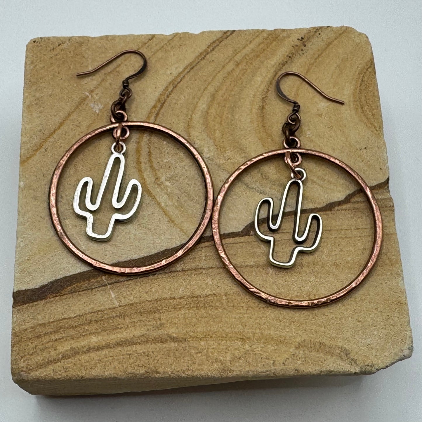 Chunky silver saguaros in copper rings